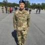 Xilong “Tony” Zhu’13 standing at attention in military garb.